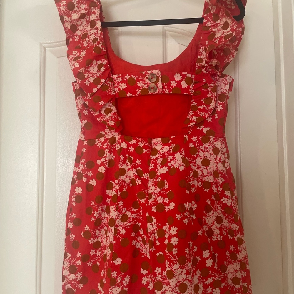 Red dress with floral pattern. Off the shoulders ruffles with cut-out in back
